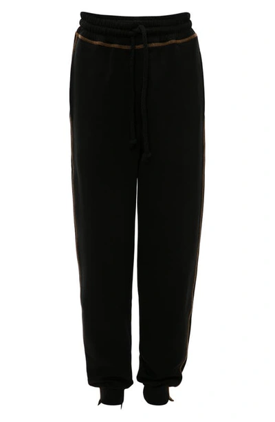 Shop Jw Anderson Tapered Track Pants In Black