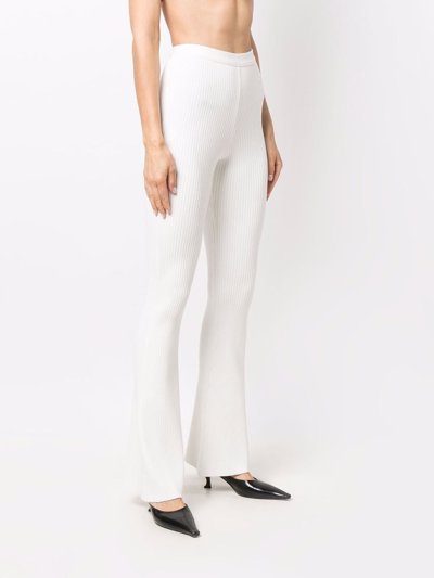 Shop Courrèges Ribbed High-waisted Flared Leg Trousers In White