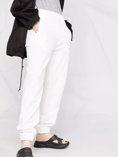 Shop Moncler Tapered Cotton Track Pants In White