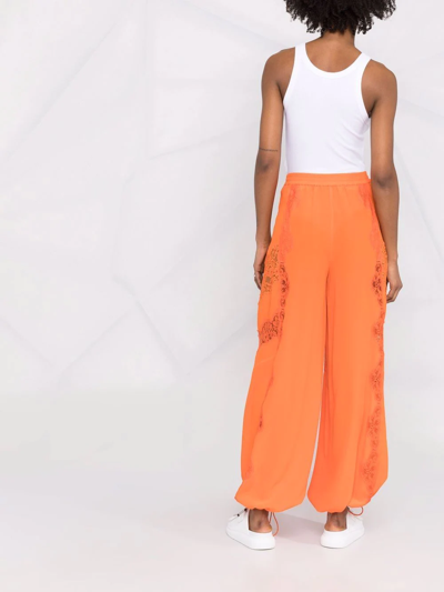 Shop Stella Mccartney Lace-insert Parachute Trousers In Orange