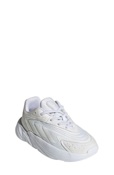 Shop Adidas Originals Kids' Ozelia Sneaker In White/ White/ White