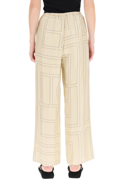 Shop Totême Toteme Monogram Embroidered Pajama Trousers In Beige