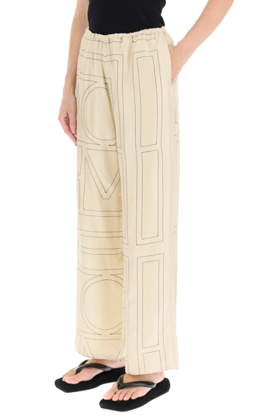 Shop Totême Toteme Monogram Embroidered Pajama Trousers In Beige