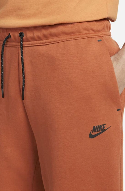 Shop Nike Sportswear Tech Fleece Shorts In Burnt Sunrise/ Black