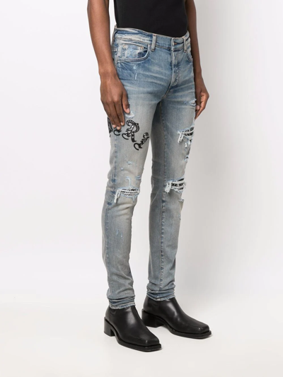 Shop Amiri Logo Distressed Skinny Jeans In Blue