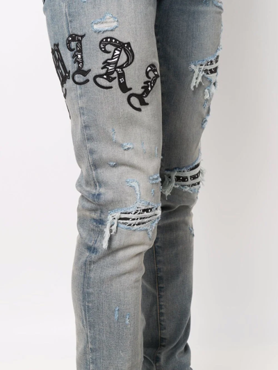 Shop Amiri Logo Distressed Skinny Jeans In Blue