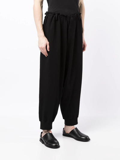 Shop Yohji Yamamoto Tapered-leg Cotton Trousers In Black