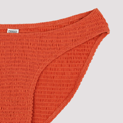 Shop Totême Smocked Bikini Bottom Swimwear In Yellow &amp; Orange