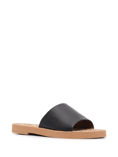 Shop See By Chloé Embossed-logo Leather Slippers In Schwarz