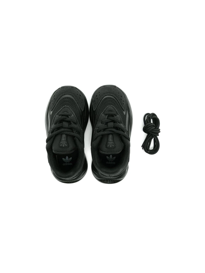 Shop Adidas Originals Ozelia Low Top Sneakers In Black