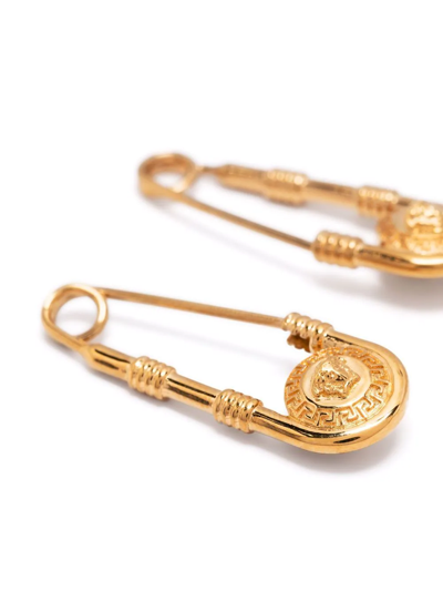 Shop Versace Safety-pin Medusa Earrings In Gold