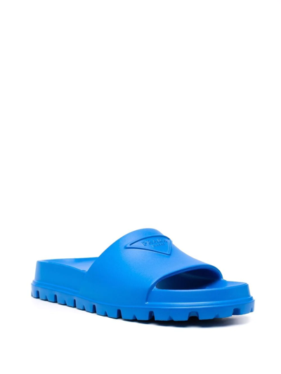 Shop Prada Embossed-logo Ridged-sole Slides In Blau