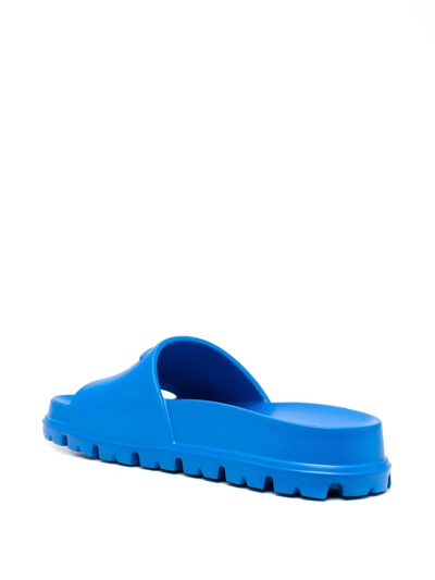 Shop Prada Embossed-logo Ridged-sole Slides In Blau