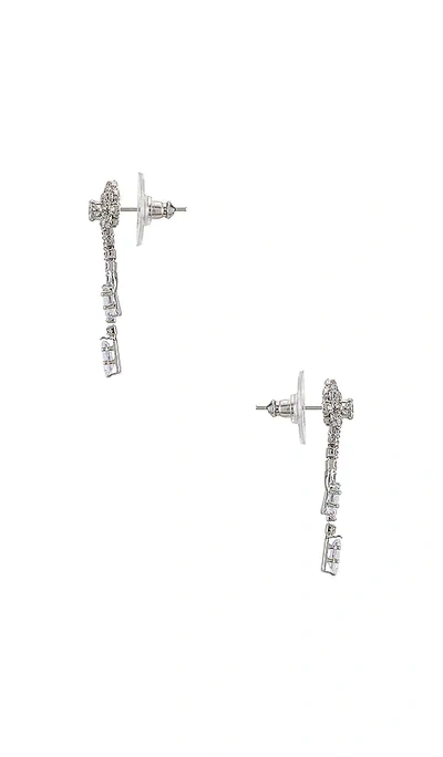 Shop Shashi Petite Bow Earrings In Metallic Silver