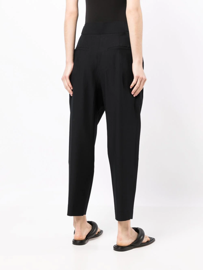 Shop Goodious Pleated Tapered-leg Trousers In Schwarz