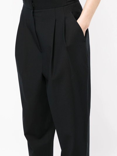 Shop Goodious Pleated Tapered-leg Trousers In Schwarz