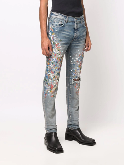 Shop Amiri Paint-splattered Skinny Jeans In Blau