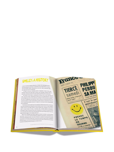 Shop Assouline Smiley: 50 Years Of Good News Book In Yellow