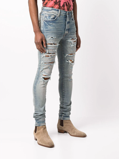 Shop Amiri Mx1 Distressed Skinny Jeans In Blau