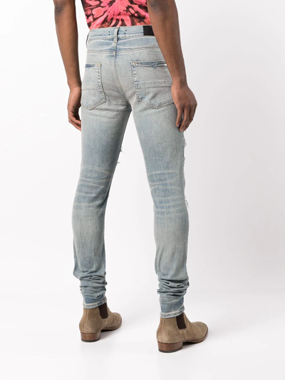 Shop Amiri Mx1 Distressed Skinny Jeans In Blau