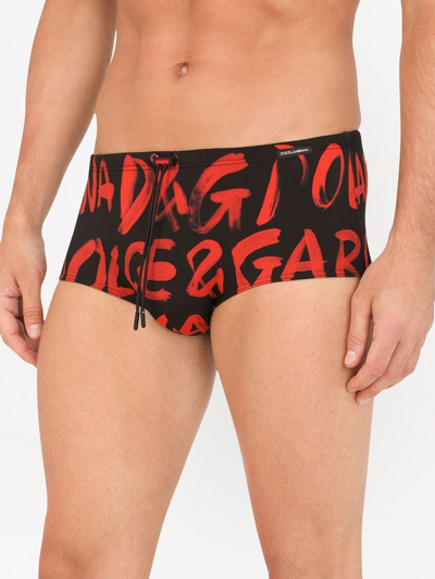 Shop Dolce & Gabbana All Over Logo-print Swimming Trunks In Black