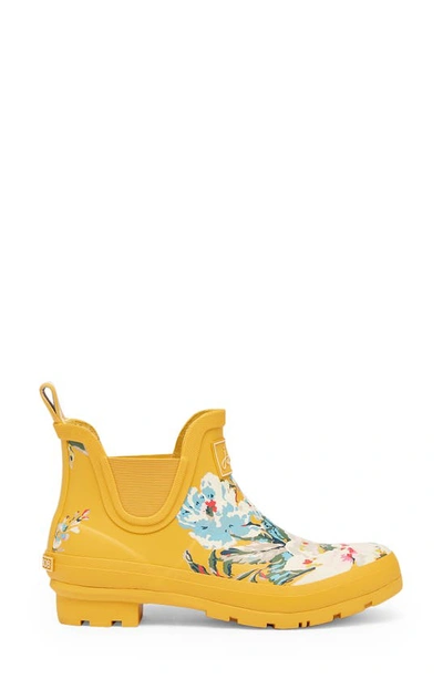 Shop Joules Wellibob Short Rain Boot In Gold Floral