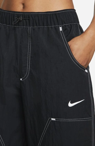 Shop Nike Sportswear Swoosh Woven Pants In Black/ Black/ White/ White