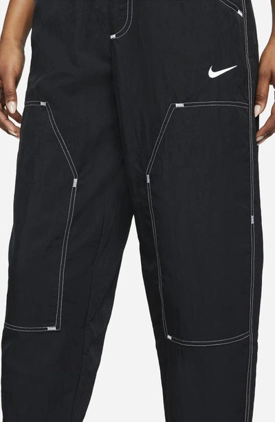 Shop Nike Sportswear Swoosh Woven Pants In Black/ Black/ White/ White