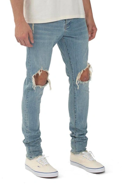 Shop Purple Ripped Knee Blowout Slim Jeans In Light Indigo Blowout