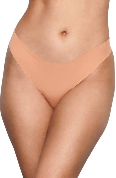 Shop Skims Naked Mid Rise Thong In Ochre