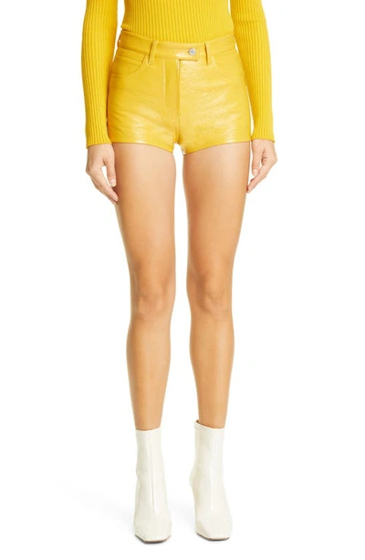 Shop Courrèges Coated Stretch Cotton Mini Shorts In Ochre
