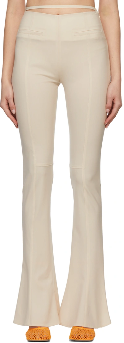 Jacquemus Tangelo Pleated Stretch-wool Flared Pants In 110 Off-white