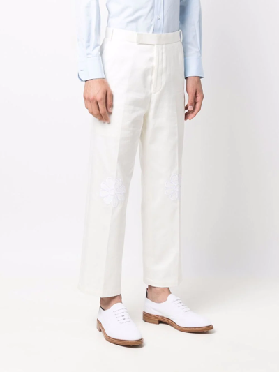 Shop Thom Browne Floral Applique Trousers In White