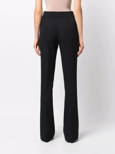Shop Genny High-waisted Flared Trousers In Black