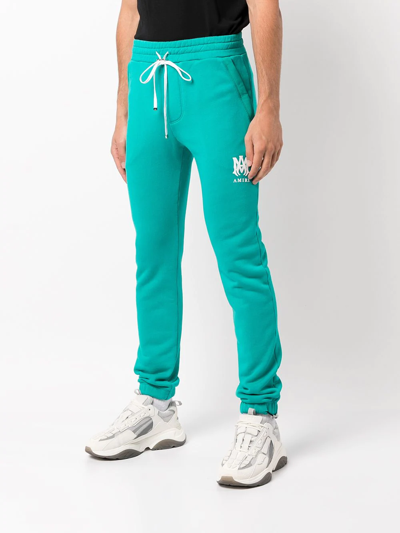 Shop Amiri Logo-print Cotton Track Trousers In Blue