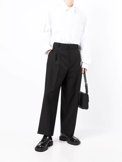 Shop Juunj Waist-buckle Ankle-crop Trousers In Black