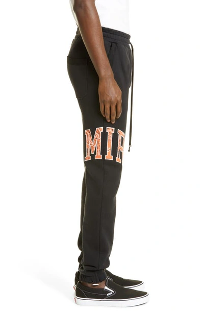 Shop Amiri Bandana Logo Appliqué Joggers In Black / Orange