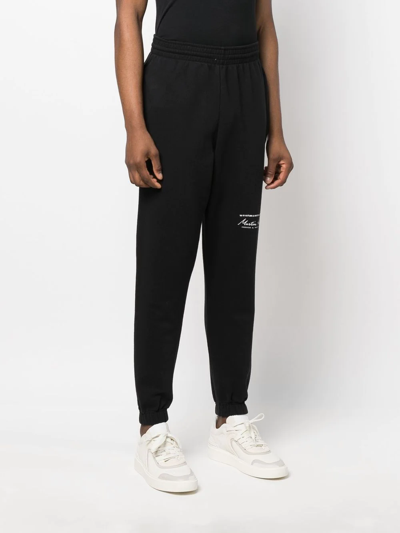 Shop Martine Rose Logo-print Slim-fit Track Pants In Schwarz