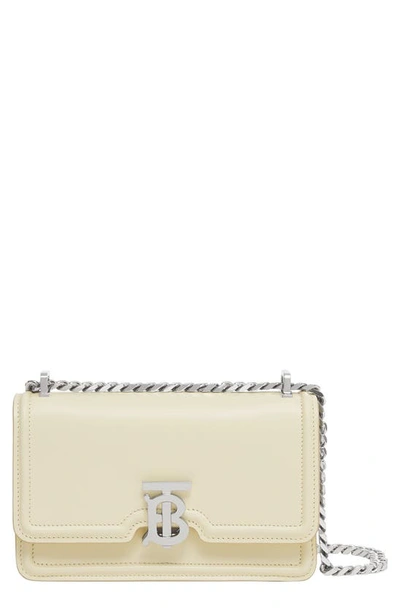 Shop Burberry Elongated Tb Leather Crossbody Bag In Pale Vanilla