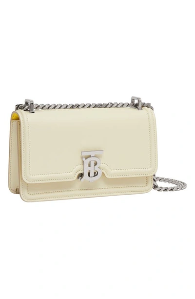 Shop Burberry Elongated Tb Leather Crossbody Bag In Pale Vanilla