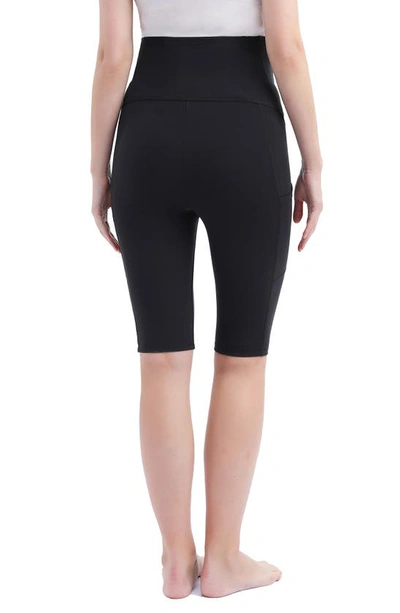 Shop Kimi And Kai Flo Belly & Back Support Pocket Maternity Capri Tights In Black