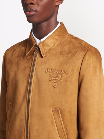 Shop Prada Embossed Logo Zipped Suede Jacket In Braun
