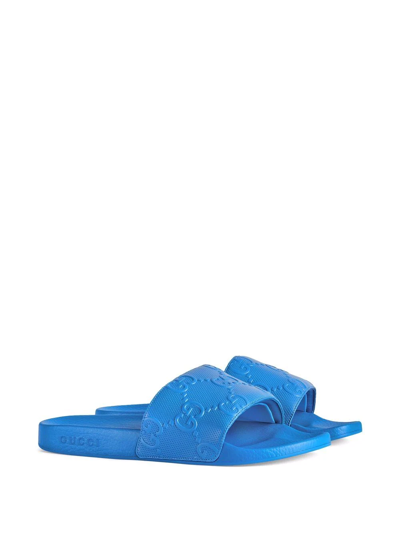 Shop Gucci Gg-embossed Slides In Blau