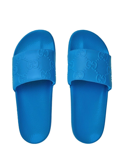Shop Gucci Gg-embossed Slides In Blau