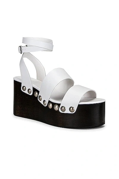 Alaïa 85mm Wooden-heel Wedge Sandals With Shiny Leather Straps And Studs In Blanc Casse