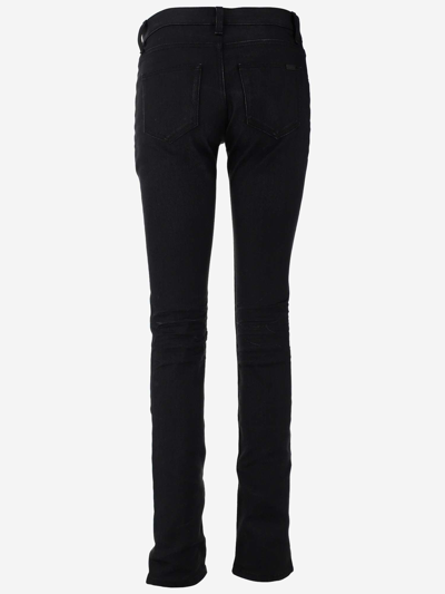Shop Saint Laurent Low Rise Jeans In Used Black