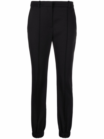 Shop Alexander Mcqueen Elasticated-ankle Tailored Trousers In Schwarz