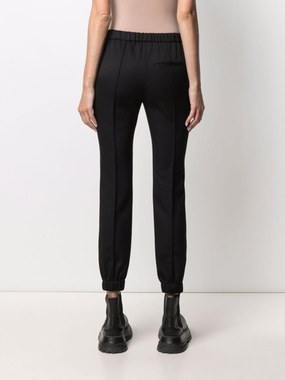 Shop Alexander Mcqueen Elasticated-ankle Tailored Trousers In Schwarz