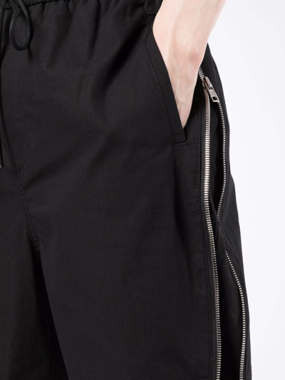 Shop Juunj Exposed Zip Double Layer Shorts In Schwarz