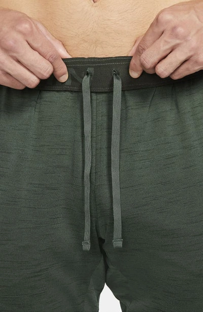 Shop Nike Pocket Yoga Pants In Galactic Jade/ Sequoia